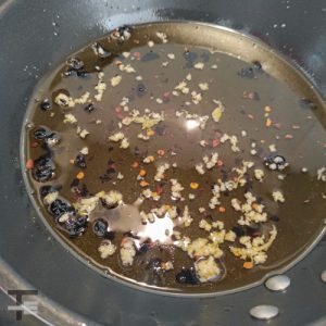 Infuse olive oil with garlic, black garlic and chilli flakes